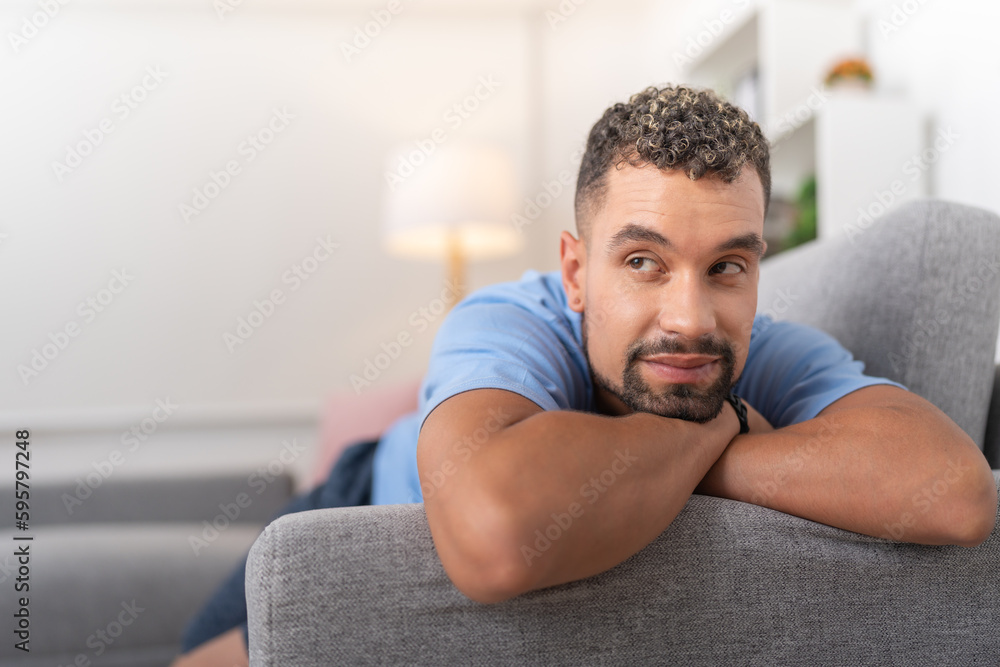 Young man thinking about his girlfriend, lying down on the sofa Young man thinking about his girlfriend, lying down on the sofa