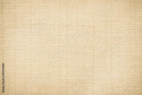 Jute hessian sackcloth canvas woven texture pattern background in light beige cream brown color blank empty 