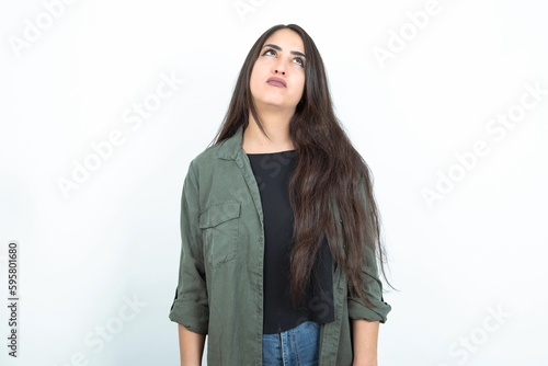 young brunette woman wearing casual clothes over white studio background looking sleepy and tired, exhausted for fatigue and hangover, lazy eyes in the morning.