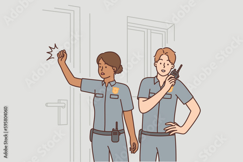 Police officers knock on door arriving on call after robbery or crime in need sheriff investigation