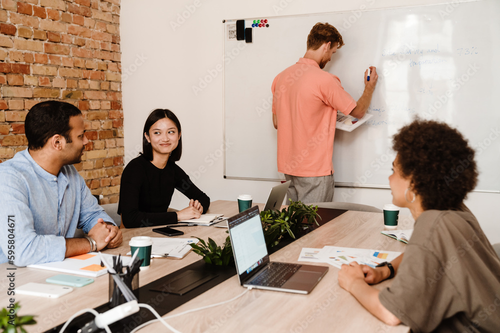 Man making presentation to his colleagues at office Man making presentation to his colleagues at office
