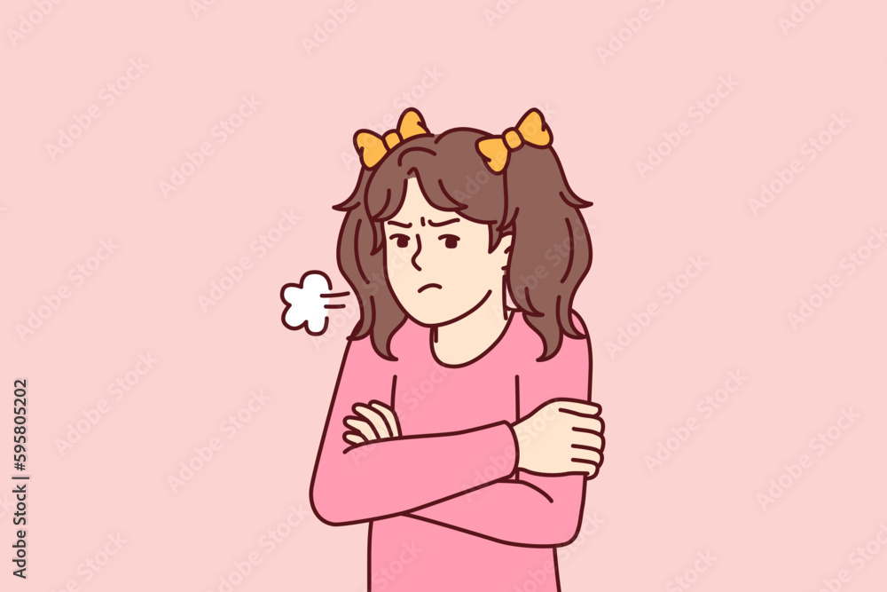 Angry little girl stands with arms crossed feeling hurt after being punished by kindergarten staff. Pre-teenage girl feels resentful after argument with parents or elementary school teachers Angry little girl stands with arms crossed feeling hurt after being punished by kindergarten staff. Pre-teenage girl feels resentful after argument with parents or elementary school teachers