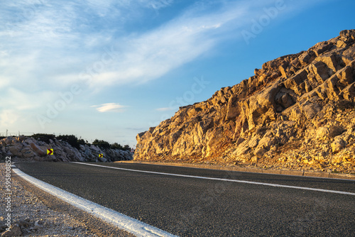 Fototapeta Naklejka Na Ścianę i Meble -  An asphalt road running past a beautiful viewpoint on the Island of Pag,Croatia.