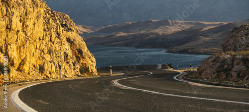Fototapeta Naklejka Na Ścianę i Meble -  An asphalt road running past a beautiful viewpoint on the Island of Pag,Croatia.