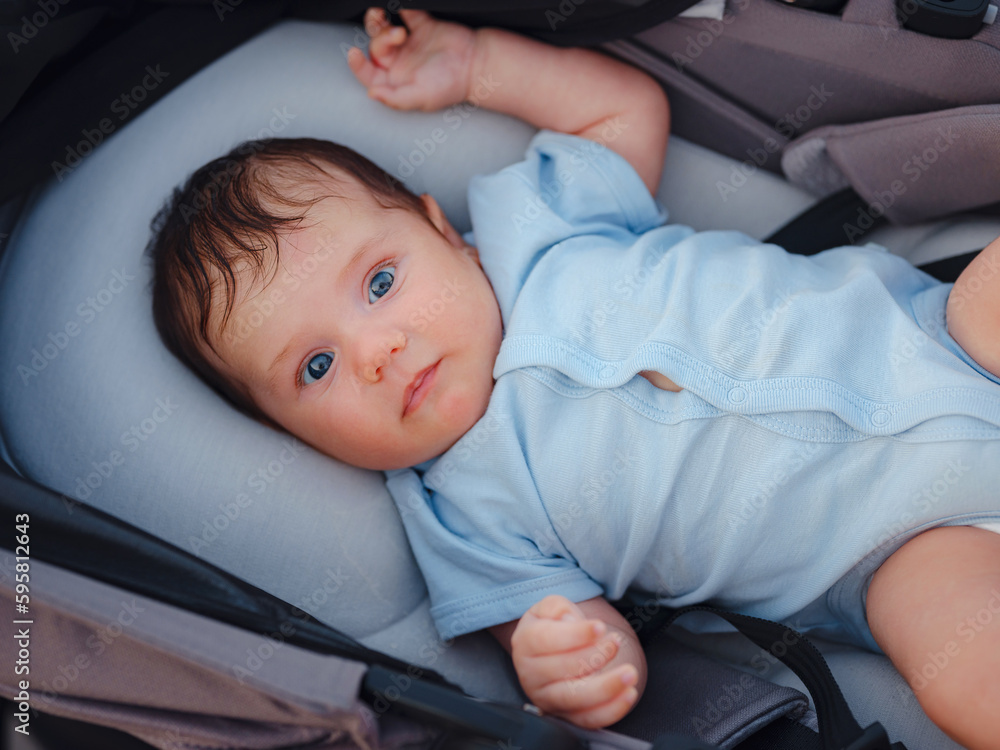Baby in stroller in summer park Baby in stroller in summer park