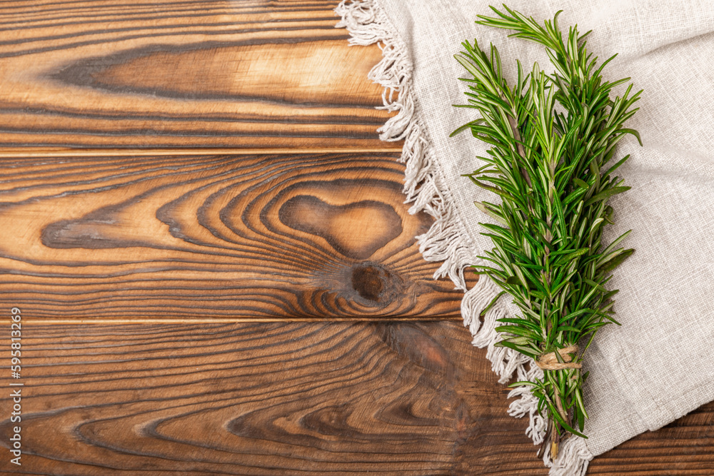 Branches of fresh rosemary on a brown texture background. Spicy spices. Seasoning for meat and fish. Cooking concept. RECEPT. Close-up. place for text. Branches of fresh rosemary on a brown texture background. Spicy spices. Seasoning for meat and fish. Cooking concept. RECEPT. Close-up. place for text.