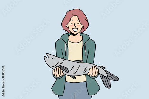 Smiling woman holding fish in hands excited with successful fishing. Happy female fisher with haul. Hobby and entertainment. Vector illustration. 