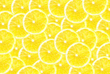 Dry yellow lemon slices background. Yellow fruit cut texture. Lemon cross section pattern. Vibrant color citrus.