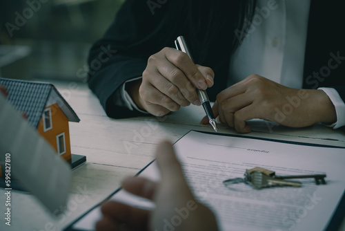 Real estate agents recommend interest rates  discuss the terms of the home purchase agreement  and ask clients to sign paperwork to legalize the contract.