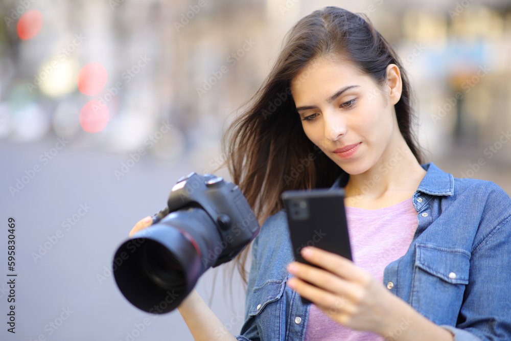 Photographer using phone holding camera