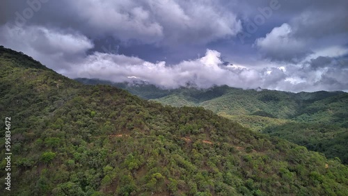 Hyperlapse featuring a hill in the foreground, with dramatic fast-moving clouds, unveiling the Sierra Madre Occidental mountain range.