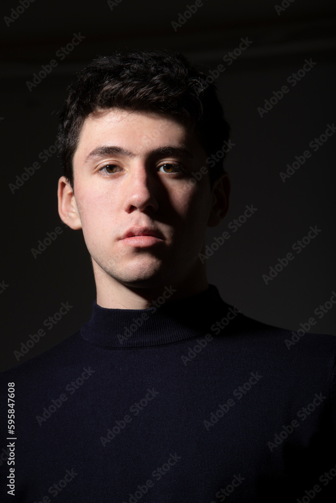 portrait of handsome boy with dark background