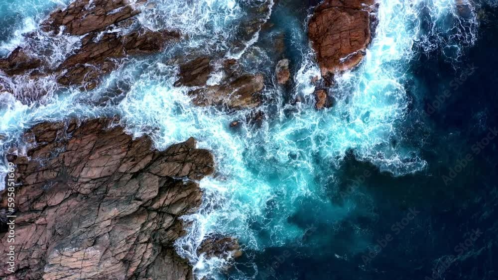 Spectacular Top Down Aerial View of Waves Crashing on the Rocky Shore Spectacular Top Down Aerial View of Waves Crashing on the Rocky Shore