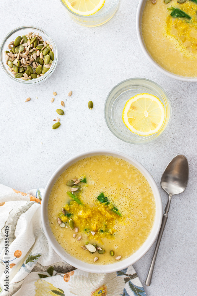 Healthy lunches, cream soup of yellow and orange lentils with fried onions and spinach leaves and curry, useful legumes, top view Healthy lunches, cream soup of yellow and orange lentils with fried onions and spinach leaves and curry, useful legumes, top view