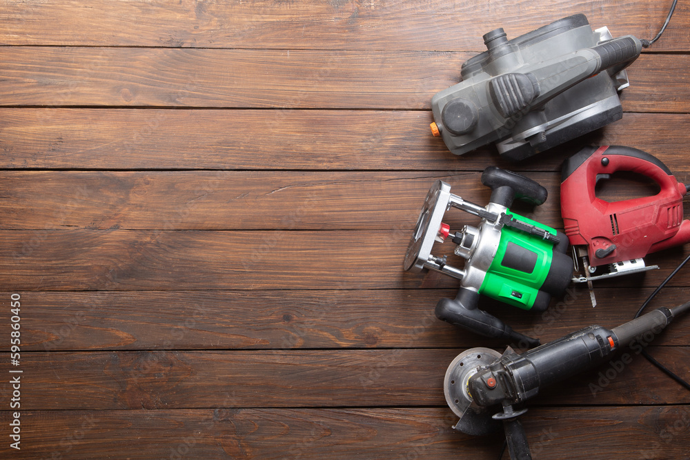 Set of electric tools on the wooden table. Various power tools for renovation and construction Set of electric tools on the wooden table. Various power tools for renovation and construction