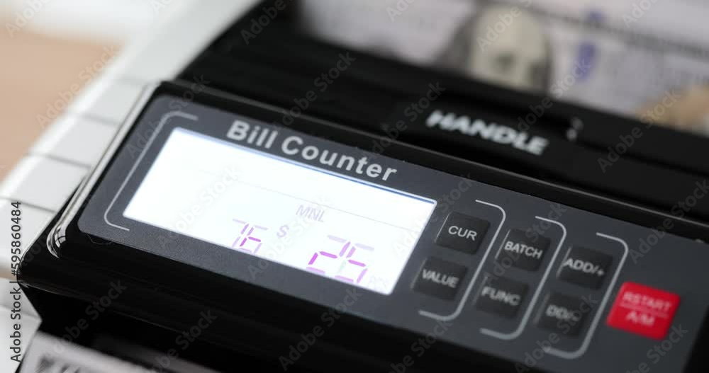 Electronic money counter machine counts one hundred dollar US dollars banknotes. Banknote counters and currency detectors Electronic money counter machine counts one hundred dollar US dollars banknotes. Banknote counters and currency detectors