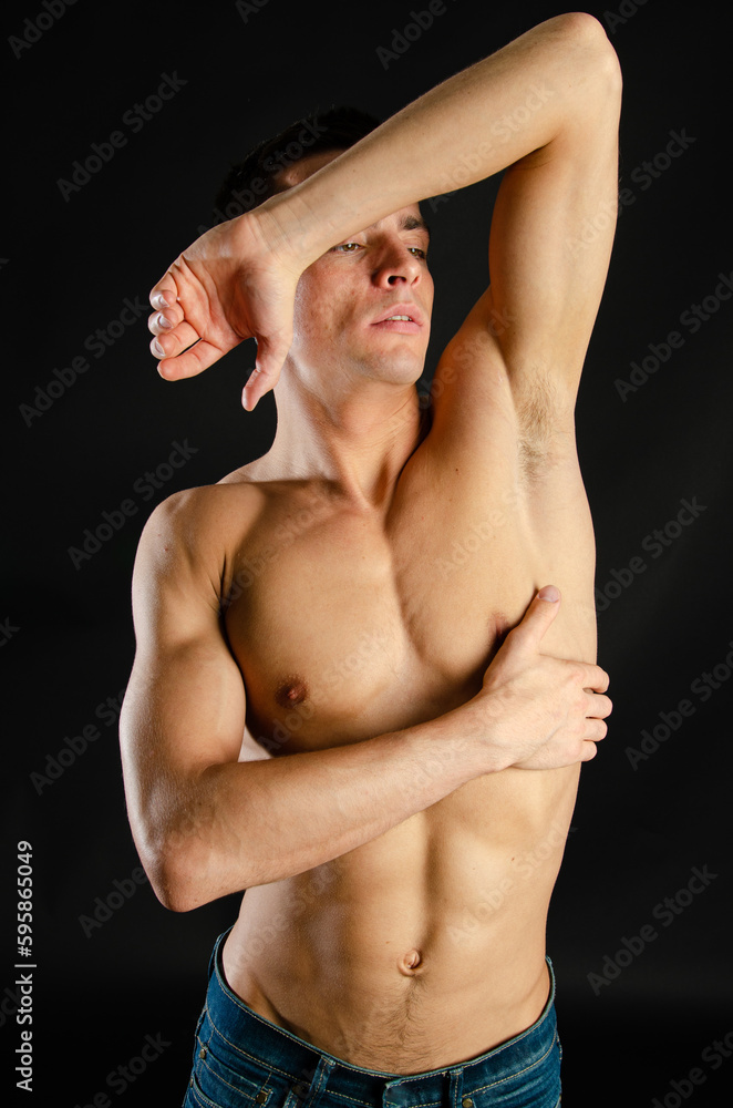Young attractive man posing in the studio. Young attractive man posing in the studio.