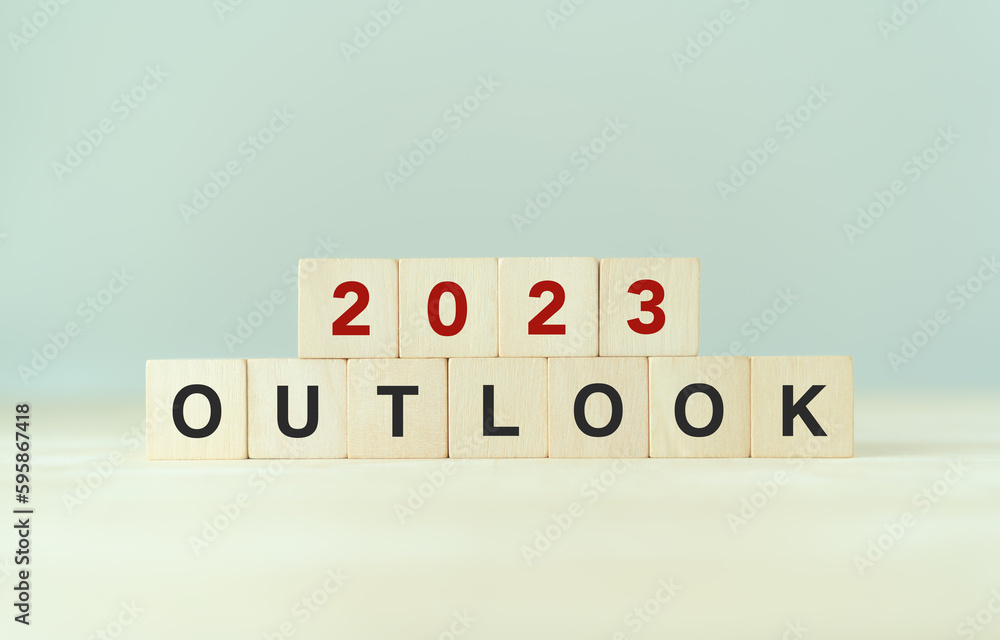 Economic outlook concept. Financial, business review or economic growth forecast for 2023. OUTLOOK 2023 text on wooden cube blocks. Economic outlook concept. Financial, business review or economic growth forecast for 2023. OUTLOOK 2023 text on wooden cube blocks.