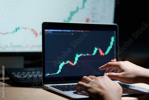 trader working in modern office, looking at display, sale and buy and analyzing index on market diagram.