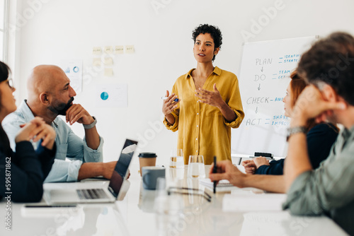 Business woman giving a speech in a boardroom meeting photo