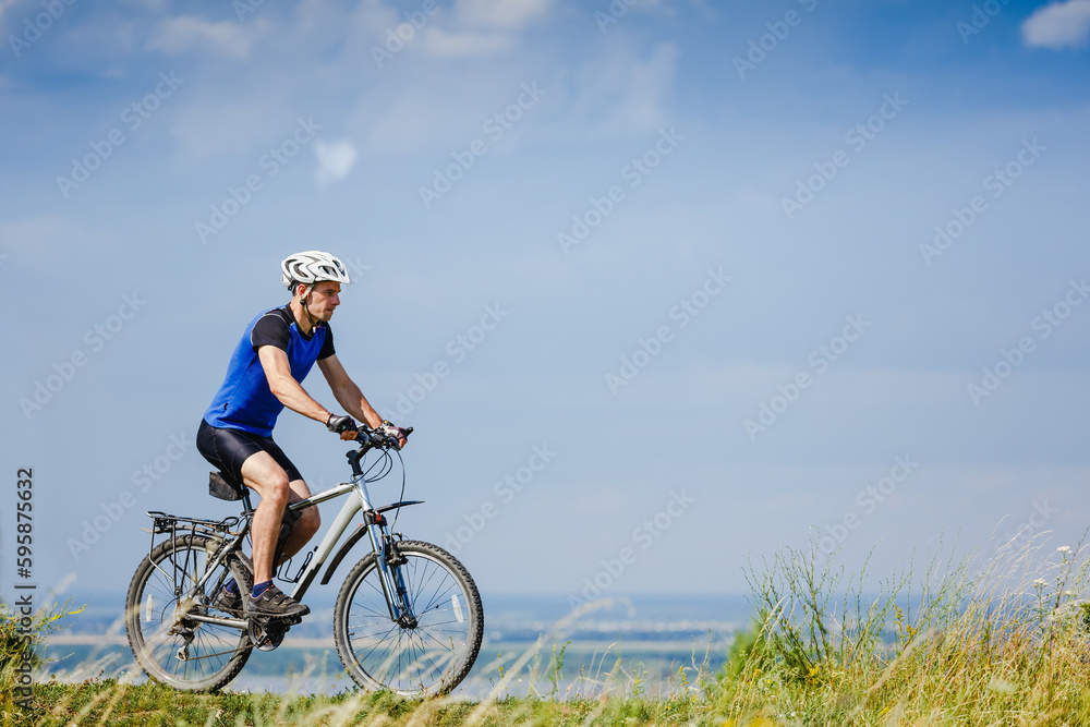 Happy Young man is riding bicycle outside. Healthy Lifestyle