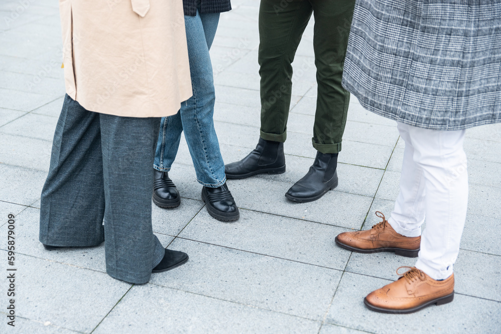 Unrecognizable businesspeople stand in a group in front of an office building. Body parts of business people in smart dressing idea innovation and tactics, sharing information and statistics Unrecognizable businesspeople stand in a group in front of an office building. Body parts of business people in smart dressing idea innovation and tactics, sharing information and statistics