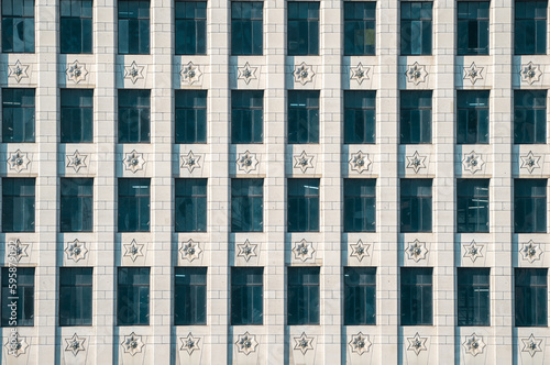 Windows in an office building with a decorative stone facade