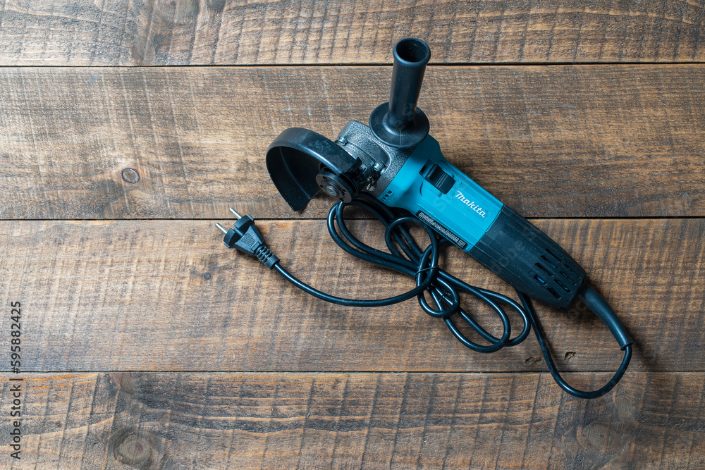 Kyiv, Ukraine - Sep, 21, 2022 : Professional angle grinder Makita GA 5030  on a wooden table. Electric work tool Makita Stock Photo | Adobe Stock