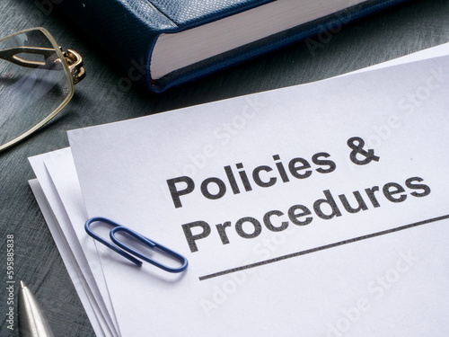 Documents about policies and procedures are on the table.