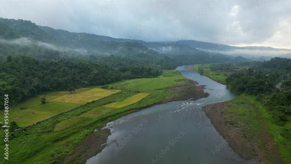 Fields And Rainforest With Flowing River In Catanduanes, Philippines. Aerial Wide Shot Fields And Rainforest With Flowing River In Catanduanes, Philippines. Aerial Wide Shot