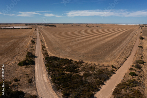 two road veering off in diagonal direction, in a rural region of South Australia, with salt lake