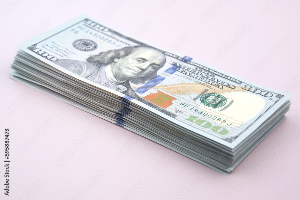 A pile of one hundred US banknotes with president portraits. A pile of one hundred US banknotes with president portraits.