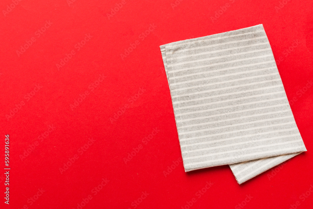 top view with gray kitchen napkin isolated on table background. Folded cloth for mockup with copy space, Flat lay. Minimal style top view with gray kitchen napkin isolated on table background. Folded cloth for mockup with copy space, Flat lay. Minimal style