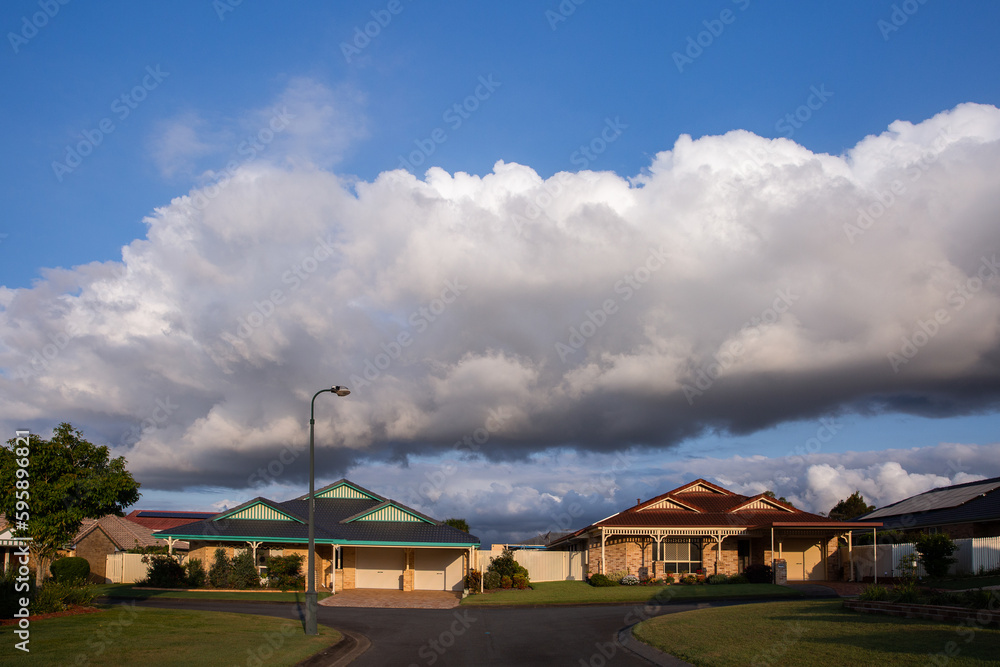 houses under a line of clouds houses under a line of clouds
