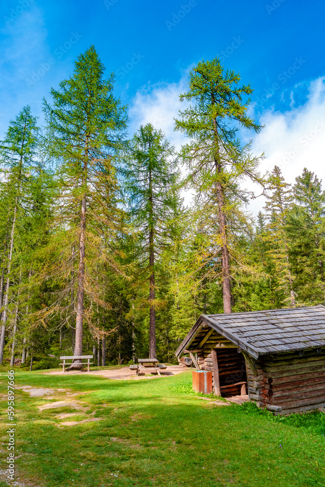 Colfosco, Corvara, South Tyrol, Italy. View of a free mountain hut in alpine pine and spruce forests Colfosco, Corvara, South Tyrol, Italy. View of a free mountain hut in alpine pine and spruce forests