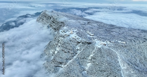 Aerial photography of snow covered Mount Emei in winter, the golden summit of Mount Emei in Sichuan(Huazang Temple), a famous Buddhist mountain in China photo