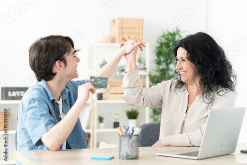 Mother and teenager son celebrating online purchase