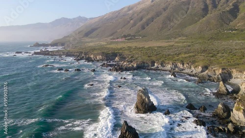 Elevated view of waves rolling over jutting rocks to shore  the Pacific Ocean located in Big Sur California