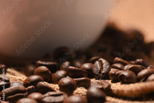 close up coffee beans with coffe cup background