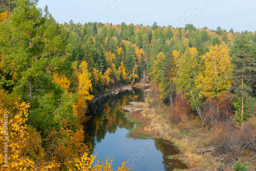 Fototapeta Naklejka Na Ścianę i Meble -  Bright autumn colors, a beautiful view from the cliff to the river valley. Walks in the open air.
