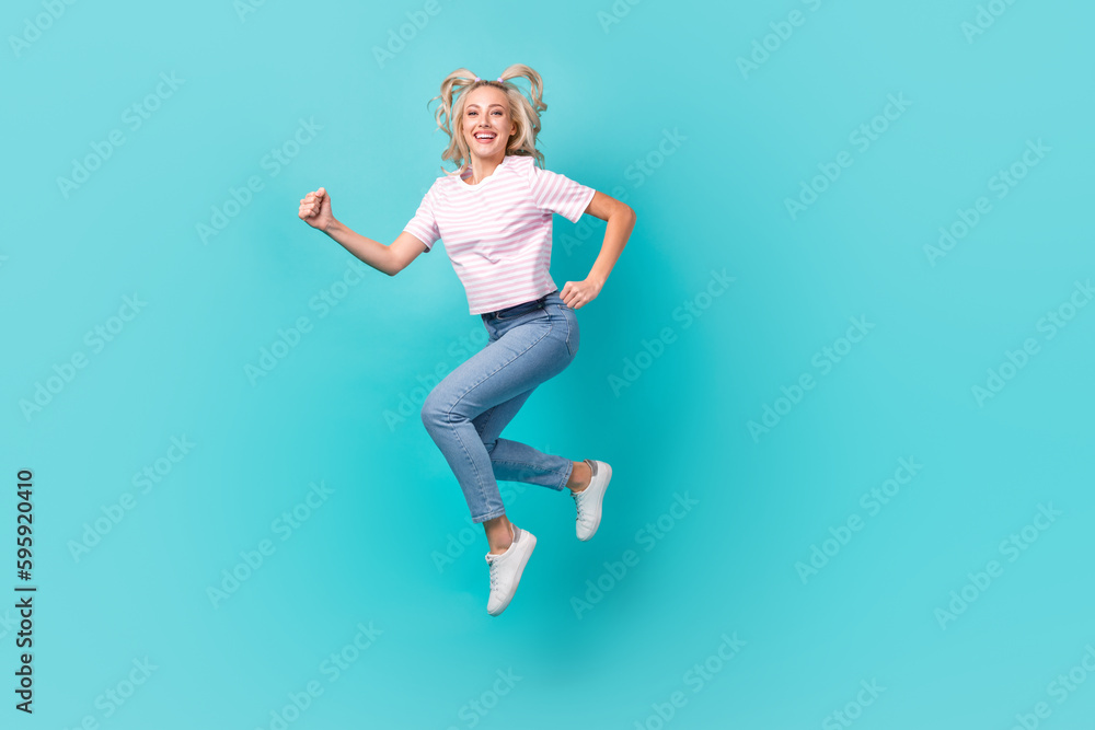 Full length photo of cheerful good mood girl wear striped t-shirt hurry running at sale isolated on vivid turquoise color background Full length photo of cheerful good mood girl wear striped t-shirt hurry running at sale isolated on vivid turquoise color background