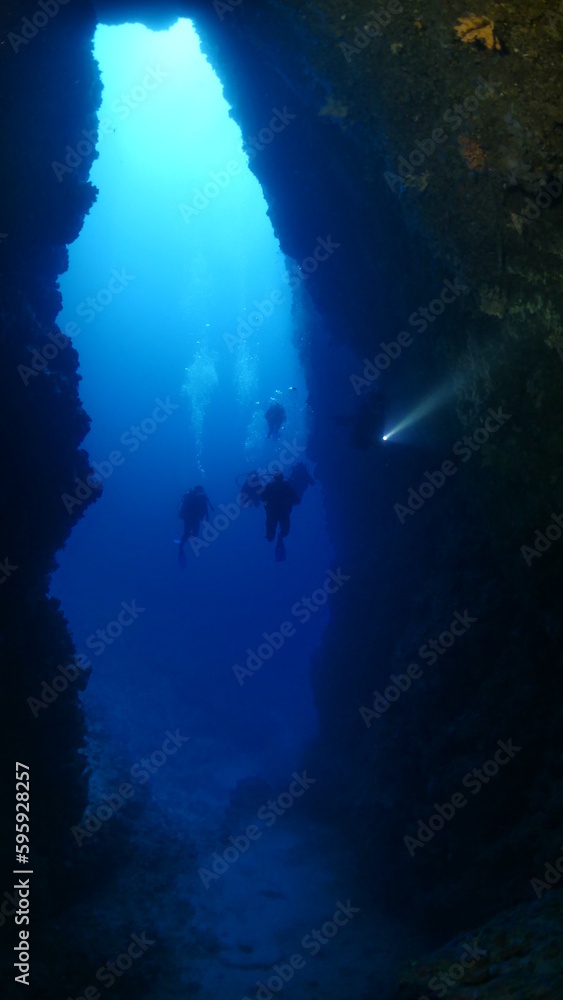 cave diving underwater exploring caves with fish and having fun ocean scenery