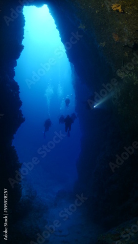 cave diving underwater exploring caves with fish and having fun ocean scenery © underocean