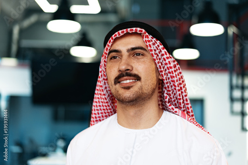 Successful muslim businessmen in traditional outfit in his office photo