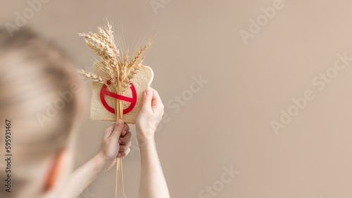 Banner for  International day of celiac disease. Child hand holding gluten free bread. No wheat concept.  photo