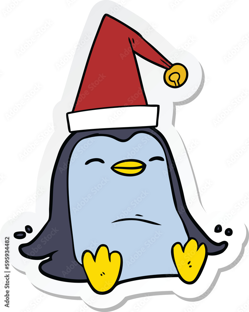 Obraz premium sticker of a cartoon penguin wearing christmas hat