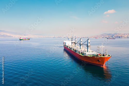 Cargo bulker grain ship waiting uploading stay at anchor near port. Aerial shot © Leonid
