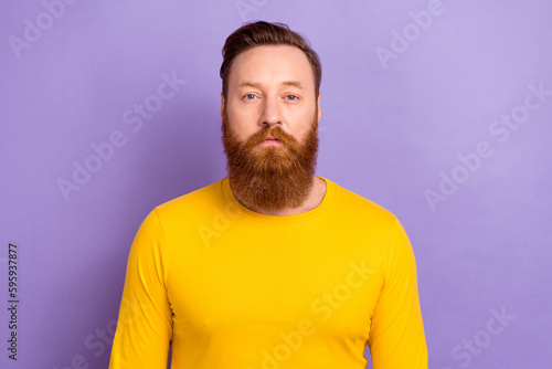 Portrait photo of young successful entrepreneur confident serious face wear yellow pullover red beard isolated on purple color background