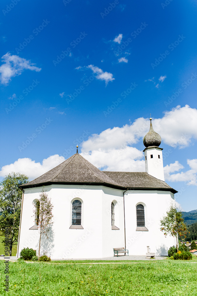 Kirche in Tirol auf einer grünen Wiese