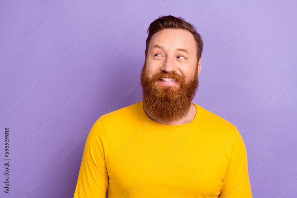 Photo portrait of young interested man business owner looking new ads makers company empty space offer isolated on violet color background Photo portrait of young interested man business owner looking new ads makers company empty space offer isolated on violet color background
